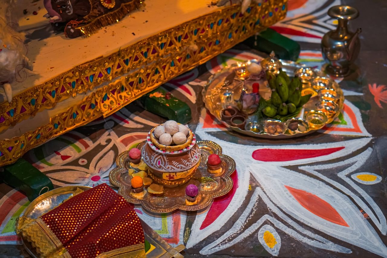 An array of items arranged for a traditional Indian religious ceremony, featuring colorful patterns and offerings.