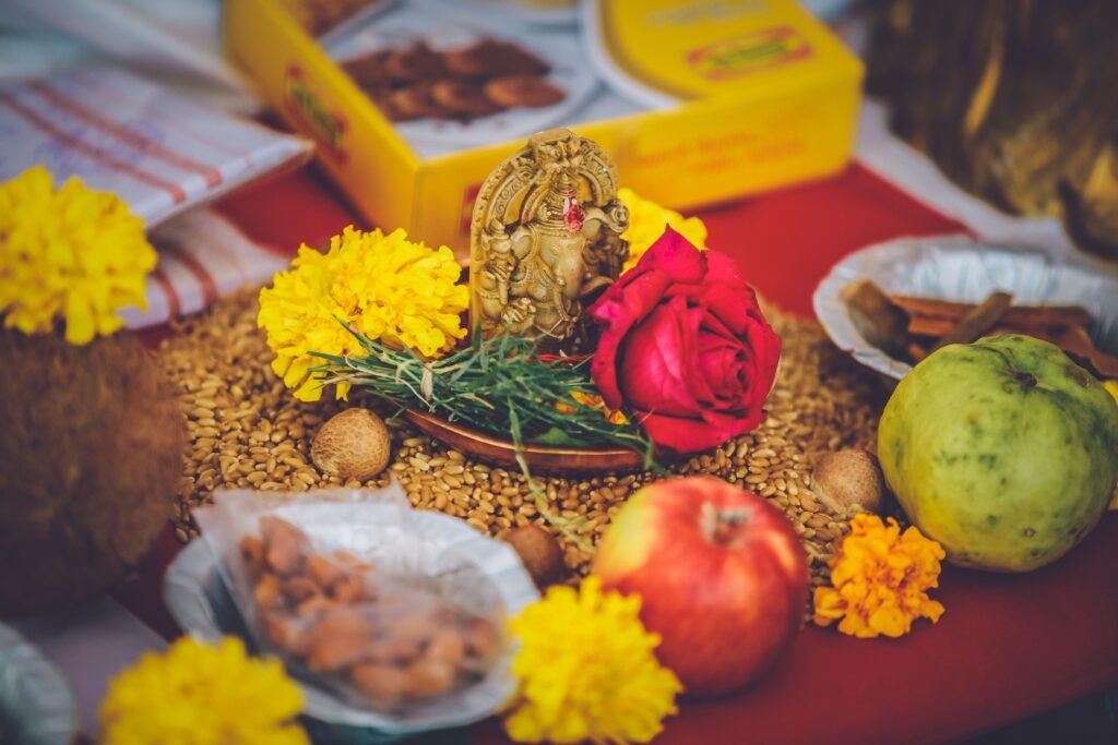 Colorful Indian ceremonial offering with flowers, fruits, and grains, symbolizing traditional culture.